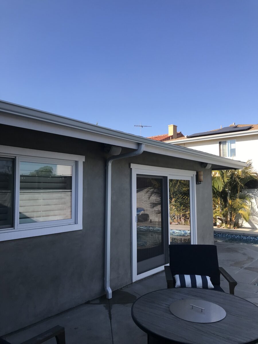 Close-up of a white 5-inch seamless gutter installed on a home, showcasing a clean and professional finish by Trustwise Construction.